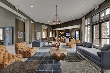 a lobby with couches and chairs and a table  at Watermark at Harvest Junction, Longmont, CO, 80501